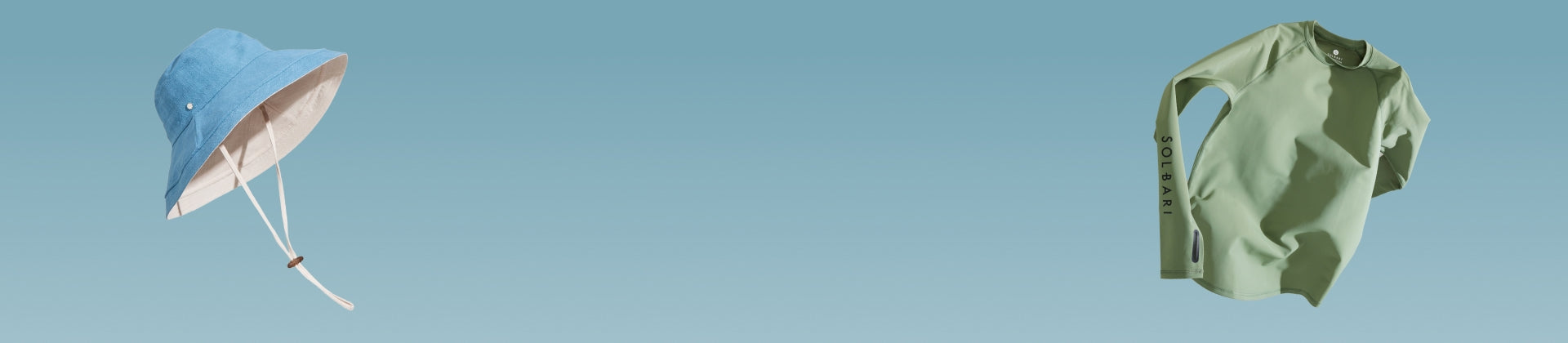 A sun hat and a light green top floating on a light blue background.