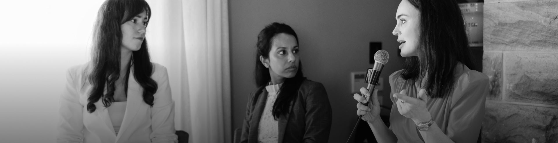 Woman speaking into a microphone with a collage of her in different poses on the left.