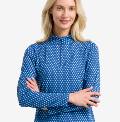 Woman wearing a blue printed long-sleeve shirt on a white background